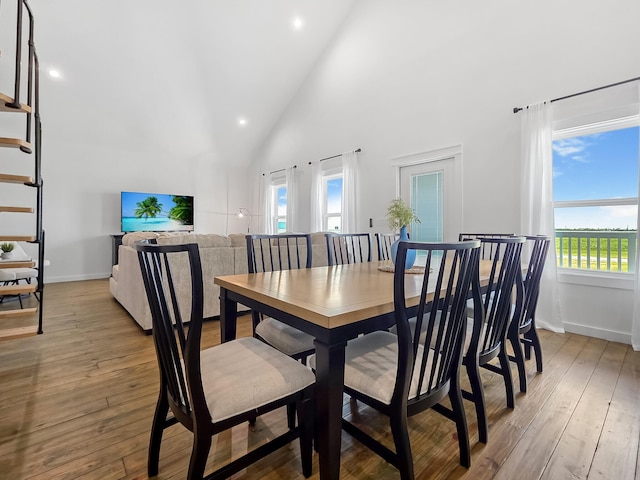 1025 Sunset Cir W, Crystal Beach, TX 77650 - dining space featuring high vaulted ceiling, light wood-style floors, and recessed lighting