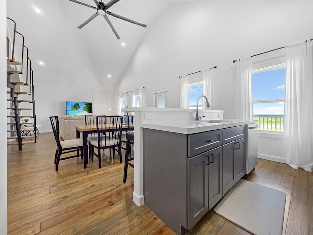 1025 Sunset Cir W, Crystal Beach, TX 77650 - kitchen featuring gray cabinets, ceiling fan, high vaulted ceiling, light countertops, and stainless steel dishwasher