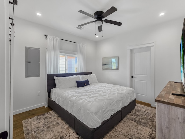 1025 Sunset Cir W, Crystal Beach, TX 77650 - bedroom featuring electric panel, wood finished floors, recessed lighting, and a ceiling fan