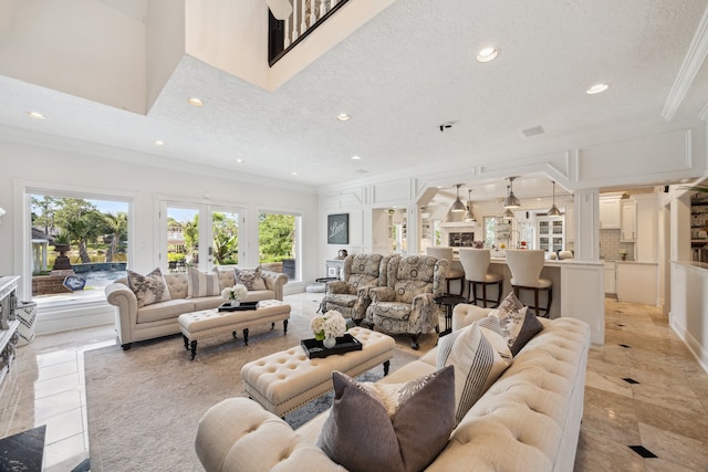 1917 Anchor Way, Dickinson, TX 77539 - living room featuring ornamental molding, healthy amount of natural light, recessed lighting, decorative columns, and light tile patterned floors