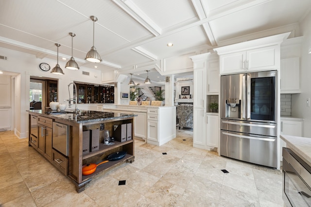 1917 Anchor Way, Dickinson, TX 77539 - kitchen featuring stainless steel fridge with ice dispenser, a kitchen island with sink, white cabinets, light stone counters, and open shelves