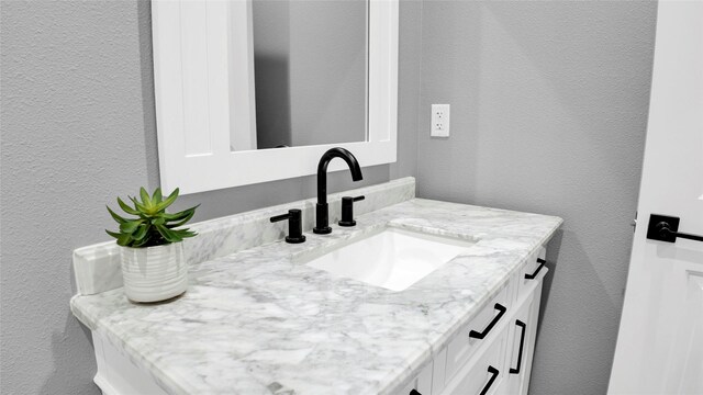 1025 Sunset Cir W, Crystal Beach, TX 77650 - bathroom with a textured wall and vanity