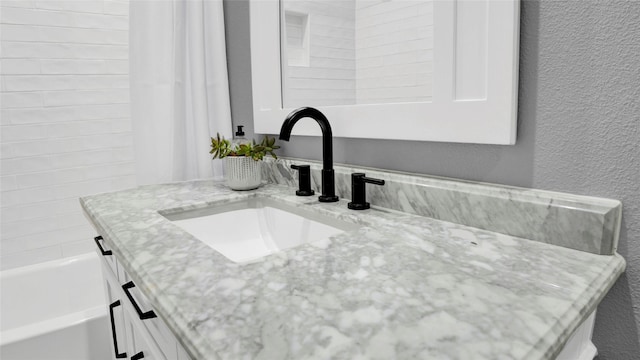1025 Sunset Cir W, Crystal Beach, TX 77650 - bathroom view of vanity and a textured wall