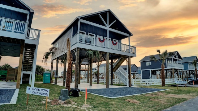 1025 Sunset Cir W, Crystal Beach, TX 77650 - view of front of house featuring stairs, board and batten siding, and a wooden deck
