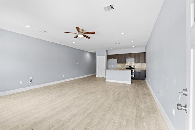 4534 Maggie St, Houston, TX 77051 - unfurnished living room featuring ceiling fan, baseboards, light wood-style flooring, recessed lighting, and a sink