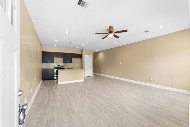 4534 Maggie St, Houston, TX 77051 - unfurnished living room with a ceiling fan, a sink, baseboards, light wood-style flooring, and recessed lighting