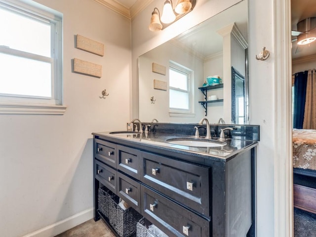 674 Ravensworth Dr, Conroe, TX 77302 - full bathroom with double vanity, ornamental molding, and baseboards
