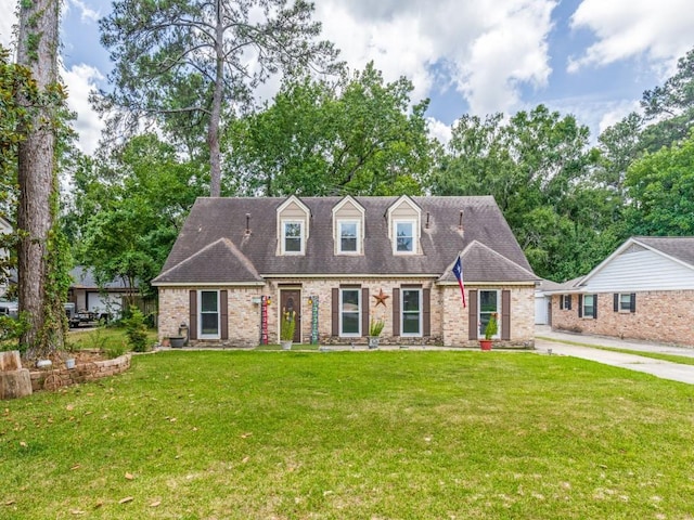 674 Ravensworth Dr, Conroe, TX 77302 - cape cod home with a front lawn, brick siding, and driveway