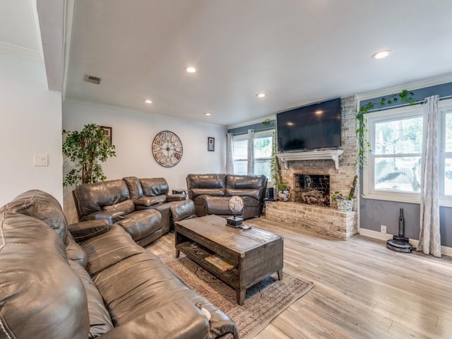 674 Ravensworth Dr, Conroe, TX 77302 - living room with ornamental molding, light wood-style flooring, a brick fireplace, recessed lighting, and baseboards