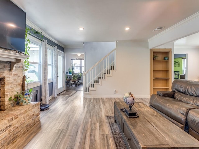 674 Ravensworth Dr, Conroe, TX 77302 - living room featuring ornamental molding, light wood-style floors, stairway, baseboards, and recessed lighting