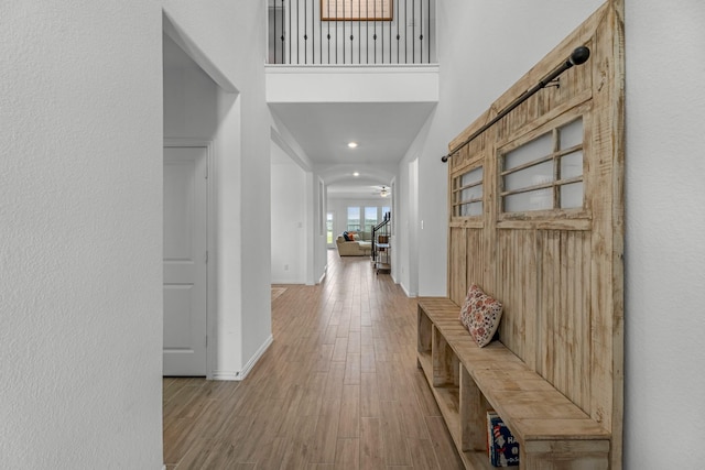 15010 Lake Shore Ave, Mont Belvieu, TX 77523 - corridor with wood finished floors, baseboards, recessed lighting, and a towering ceiling