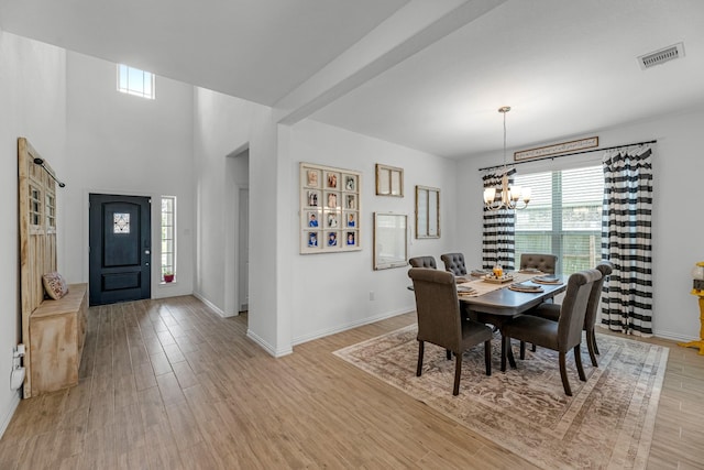 15010 Lake Shore Ave, Mont Belvieu, TX 77523 - dining area with a chandelier, light wood-style flooring, and baseboards