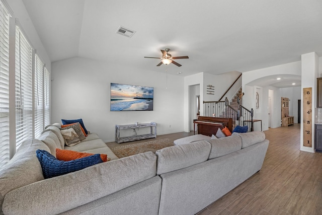 15010 Lake Shore Ave, Mont Belvieu, TX 77523 - living room with stairway, arched walkways, a ceiling fan, and wood finished floors