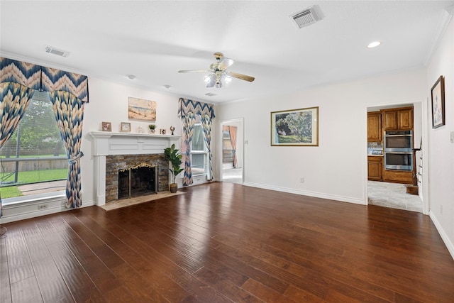 1711 Alcorn Bayou Dr, Sugar Land, TX 77479 - unfurnished living room with ceiling fan, a fireplace, crown molding, baseboards, and wood finished floors
