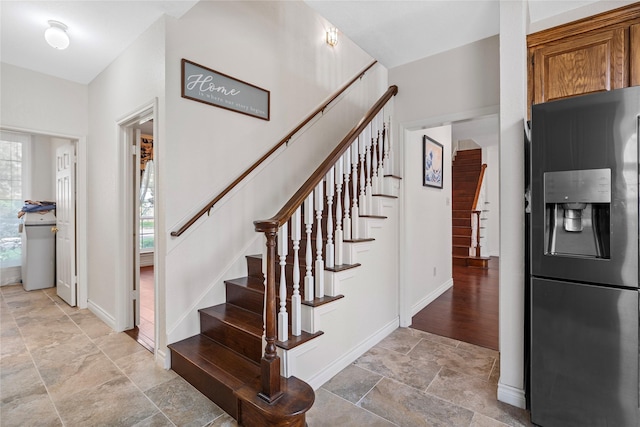 1711 Alcorn Bayou Dr, Sugar Land, TX 77479 - stairs with stone tile flooring and baseboards