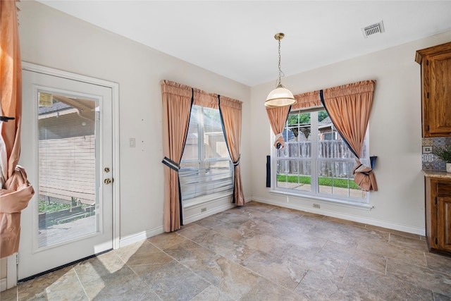 1711 Alcorn Bayou Dr, Sugar Land, TX 77479 - unfurnished dining area with stone tile floors and baseboards