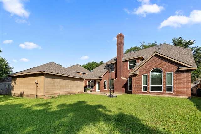 1711 Alcorn Bayou Dr, Sugar Land, TX 77479 - back of house featuring a chimney, a patio area, brick siding, and a shingled roof