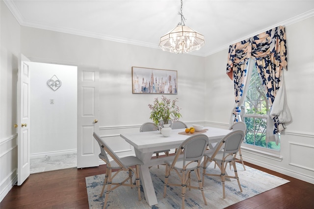 1711 Alcorn Bayou Dr, Sugar Land, TX 77479 - dining area featuring dark wood-type flooring, crown molding, a chandelier, a decorative wall, and a wainscoted wall