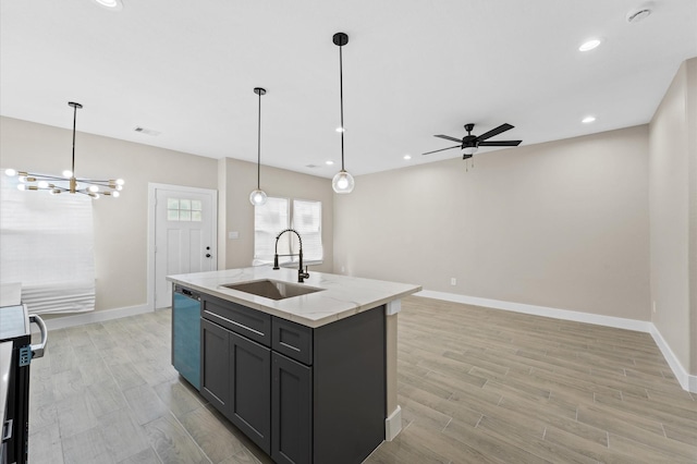 9303 Firnat St, Houston, TX 77016 - kitchen with a sink, dishwasher, a center island with sink, light wood finished floors, and baseboards