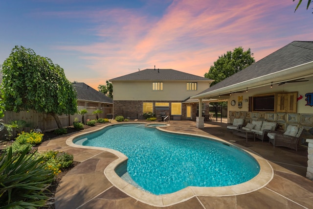 20306 Silverwood Trl, Cypress, TX 77433 - pool at dusk featuring a patio, a fenced backyard, and an outdoor living space
