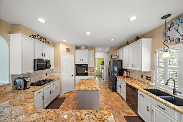 20306 Silverwood Trl, Cypress, TX 77433 - kitchen featuring black appliances, a sink, decorative backsplash, light stone countertops, and recessed lighting