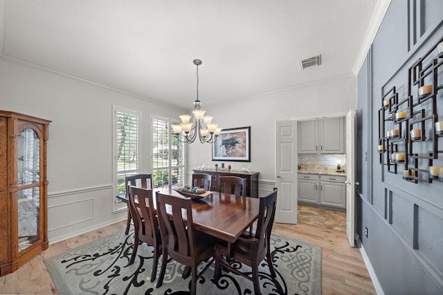 20306 Silverwood Trl, Cypress, TX 77433 - dining space with a chandelier, crown molding, and light wood finished floors