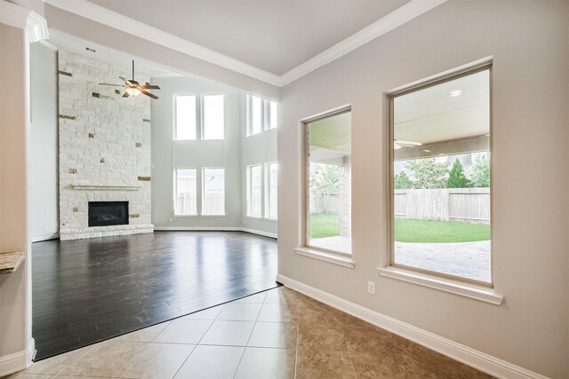 13918 Twisting Ivy Ln, Cypress, TX 77429 - unfurnished living room with ceiling fan, plenty of natural light, ornamental molding, and tile patterned flooring