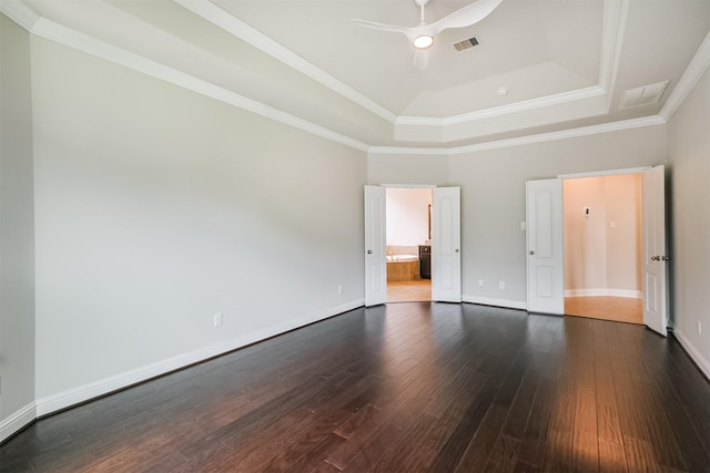 13918 Twisting Ivy Ln, Cypress, TX 77429 - unfurnished bedroom with a tray ceiling, dark wood finished floors, baseboards, ensuite bathroom, and a ceiling fan