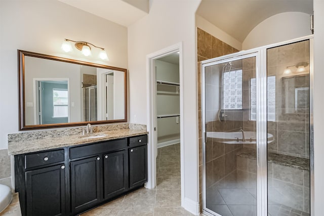 13918 Twisting Ivy Ln, Cypress, TX 77429 - bathroom with vanity, a stall shower, a walk in closet, tile patterned flooring, and lofted ceiling