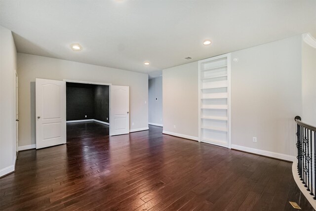 13918 Twisting Ivy Ln, Cypress, TX 77429 - unfurnished room with dark wood-type flooring, built in shelves, baseboards, and recessed lighting