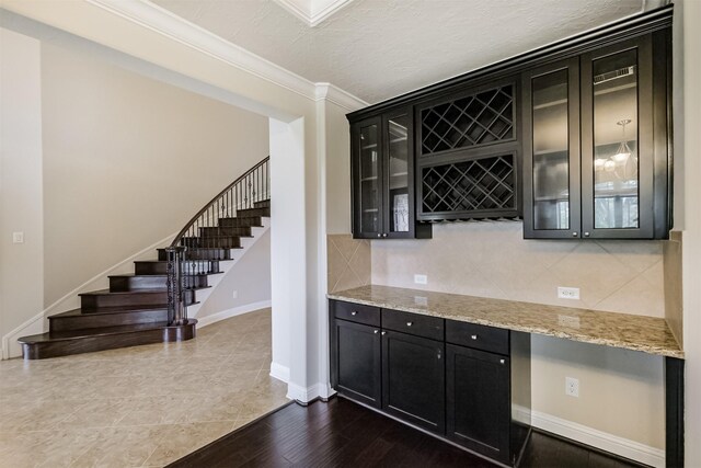 13918 Twisting Ivy Ln, Cypress, TX 77429 - indoor dry bar featuring crown molding, stairs, decorative backsplash, baseboards, and a textured ceiling