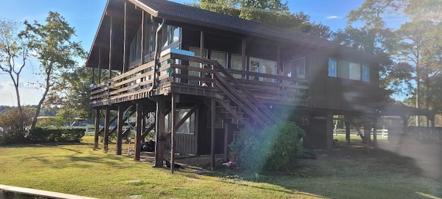 15088 Cozy Cove Ln, Willis, TX 77318 - rear view of property featuring a lawn, stairs, a shingled roof, and a sunroom