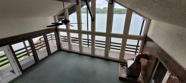 15088 Cozy Cove Ln, Willis, TX 77318 - unfurnished living room with a water view, a textured wall, a high ceiling, and ceiling fan