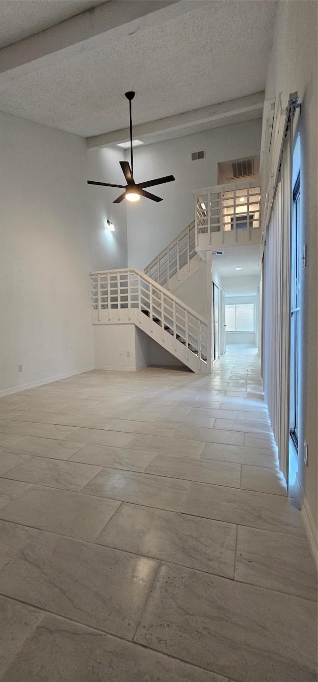 12819 Carvel Ln, Houston, TX 77072 - unfurnished living room featuring high vaulted ceiling, baseboards, ceiling fan, and a textured ceiling
