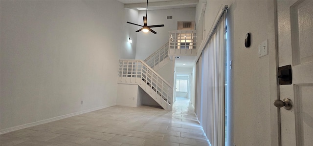 12819 Carvel Ln, Houston, TX 77072 - unfurnished living room with stairway, a towering ceiling, ceiling fan, and baseboards