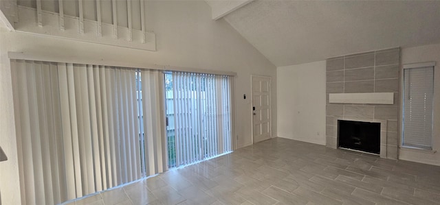 12819 Carvel Ln, Houston, TX 77072 - unfurnished living room featuring a tile fireplace and high vaulted ceiling