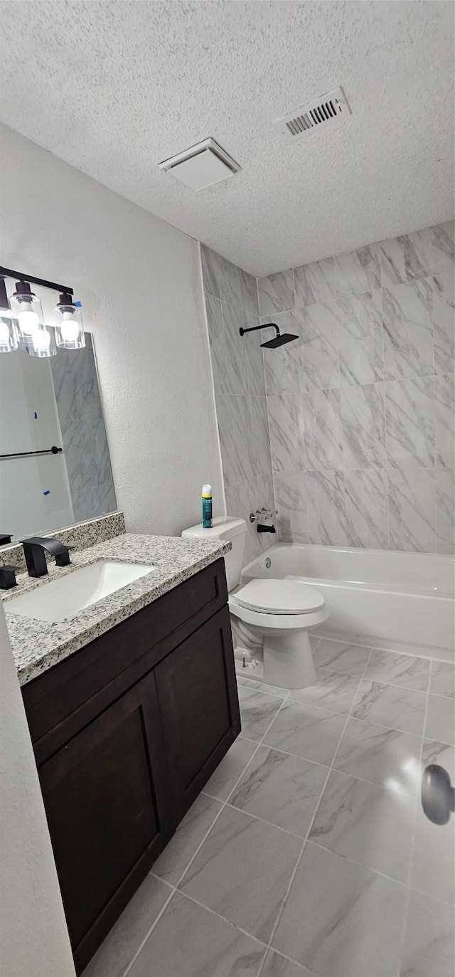 12819 Carvel Ln, Houston, TX 77072 - bathroom with vanity, shower / bathtub combination, toilet, a textured ceiling, and marble look tiles