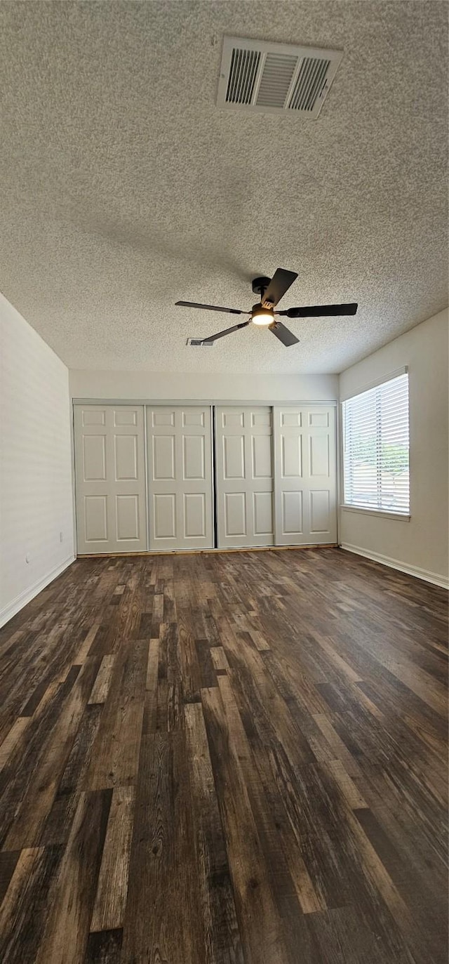 12819 Carvel Ln, Houston, TX 77072 - unfurnished bedroom with wood-type flooring, baseboards, a textured ceiling, ceiling fan, and a closet