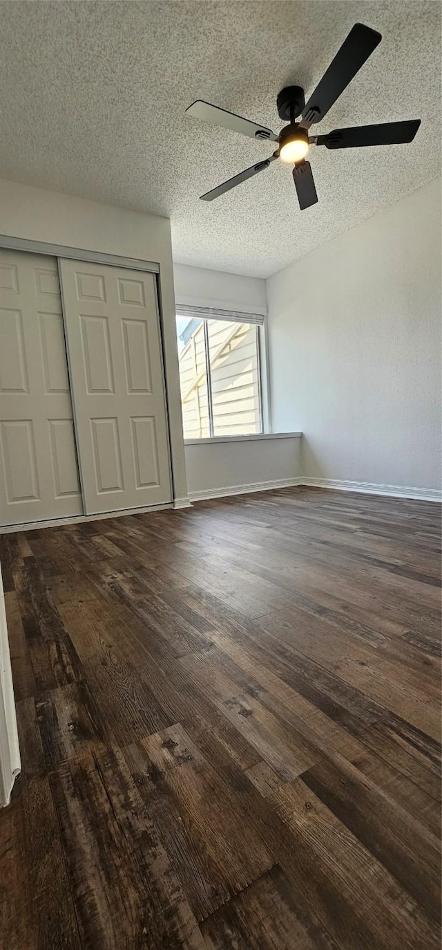 12819 Carvel Ln, Houston, TX 77072 - unfurnished bedroom with dark wood-style floors, a closet, baseboards, a textured ceiling, and ceiling fan