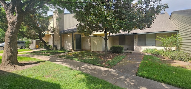 12819 Carvel Ln, Houston, TX 77072 - view of front of home featuring a front yard, brick siding, and a shingled roof