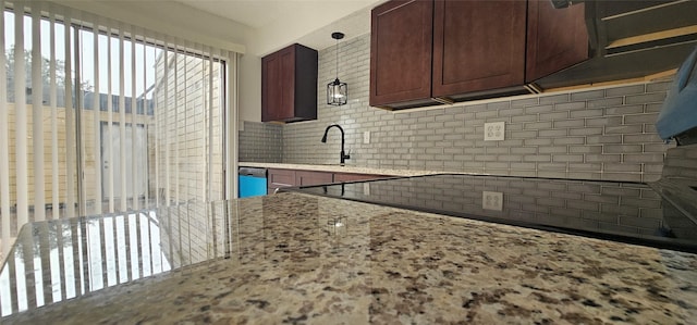 12819 Carvel Ln, Houston, TX 77072 - kitchen with decorative backsplash, light stone countertops, and a sink