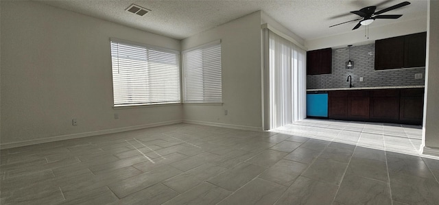12819 Carvel Ln, Houston, TX 77072 - kitchen with a ceiling fan, light countertops, dishwashing machine, a textured ceiling, and baseboards