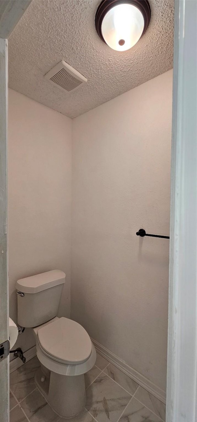 12819 Carvel Ln, Houston, TX 77072 - bathroom with toilet, baseboards, and marble finish flooring