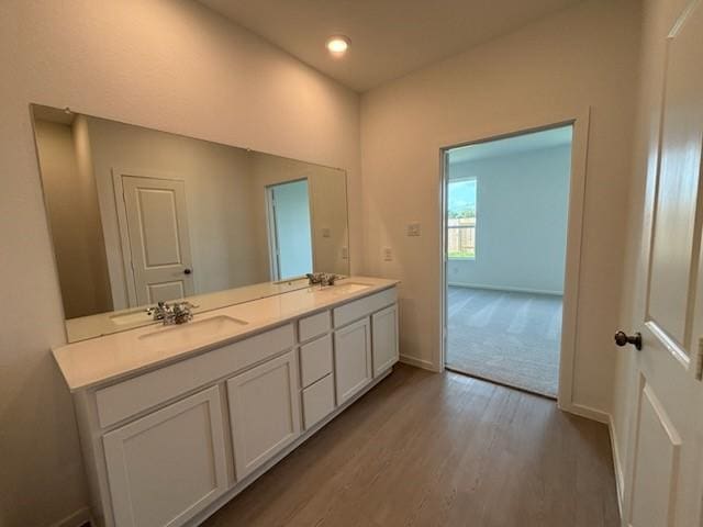 419 Robin St, Angleton, TX 77515 - bathroom with wood finished floors, double vanity, baseboards, and recessed lighting