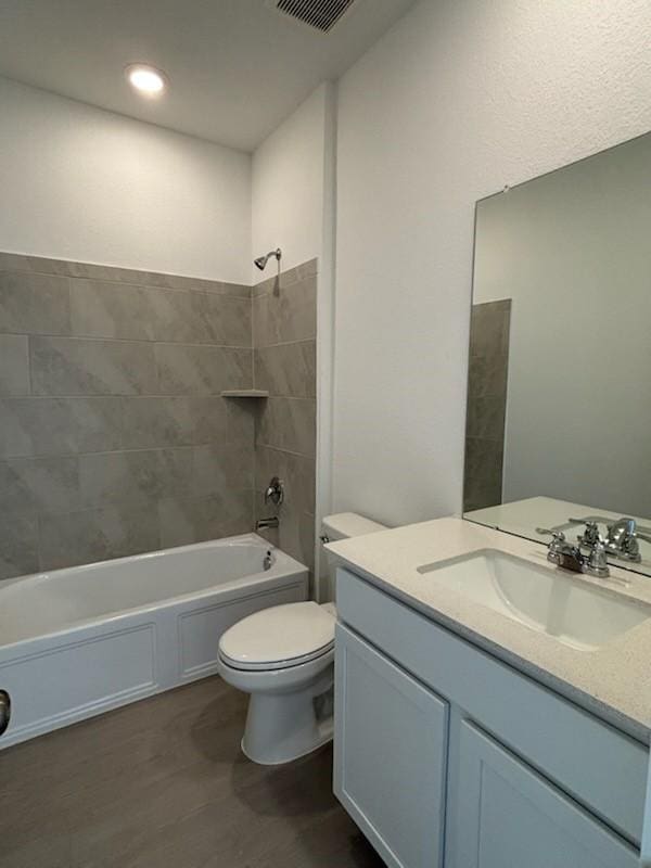 419 Robin St, Angleton, TX 77515 - full bathroom featuring vanity, shower / washtub combination, toilet, and wood finished floors