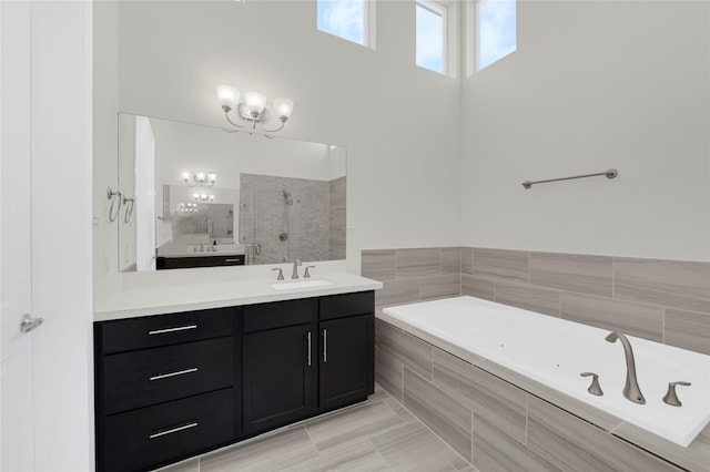 1210 Cedarpost Tree Springs Pl Unit P, Houston, TX 77055 - full bathroom featuring vanity, a whirlpool tub, tiled shower, and a chandelier