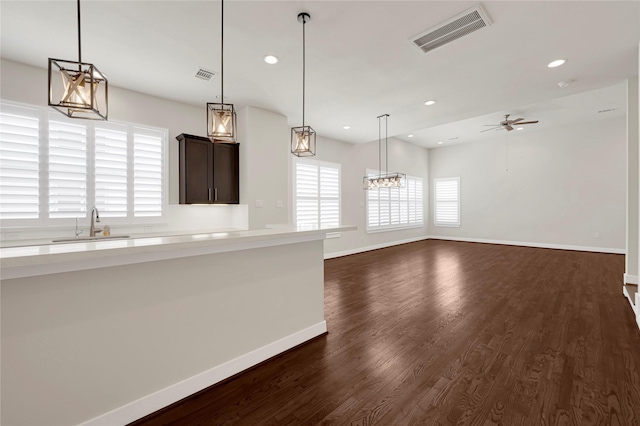 1210 Cedarpost Tree Springs Pl Unit P, Houston, TX 77055 - kitchen with light countertops, dark brown cabinetry, dark wood-style flooring, ceiling fan, and recessed lighting