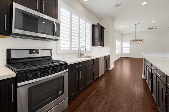 1210 Cedarpost Tree Springs Pl Unit P, Houston, TX 77055 - kitchen featuring appliances with stainless steel finishes, a sink, dark wood-type flooring, ceiling fan, and tasteful backsplash