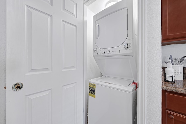 2211 S Kirkwood Rd Unit 26, Houston, TX 77077 - laundry room featuring stacked washer / drying machine
