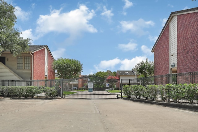 2211 S Kirkwood Rd Unit 26, Houston, TX 77077 - view of concrete road featuring a gate, a gated entry, and curbs